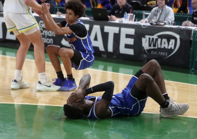 Bremerton’s Dyon Sellers reacts to their 53-52 loss to Lynden in the 2A boys basketball state semifinals in Yakima on Friday, March 1, 2024.