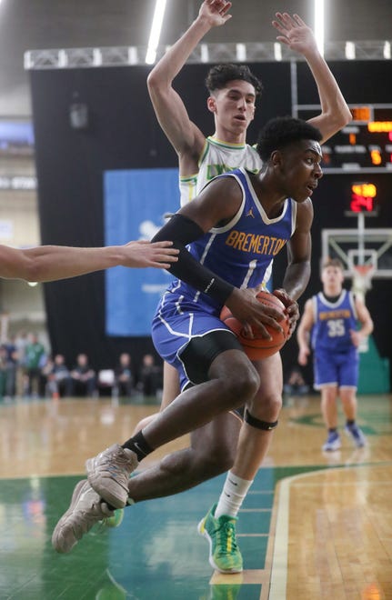 Bremerton’s Dyon Sellers drives for the basket against Lynden in the 2A boys basketball state semifinals in Yakima on Friday, March 1, 2024.