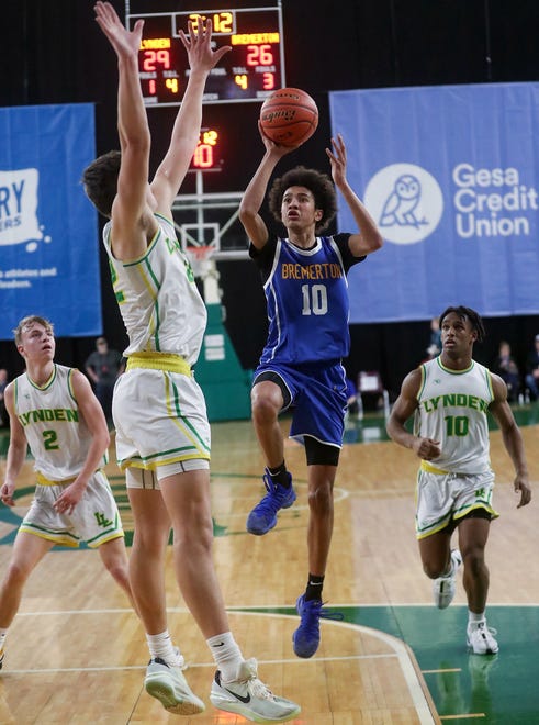 Bremerton’s Jalen Davis (10) goes up for a shot over Lynden’s Brent Heppner (22) during their 2A boys basketball state semifinals in Yakima on Friday, March 1, 2024. Lynden won the game 53-52.