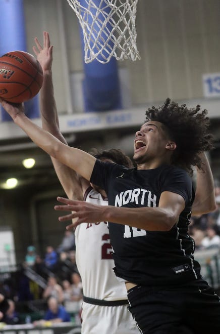 North Kitsap’s Harry Davies (12) goes up for a shot against Grandview during the 2A boys basketball state semifinals in Yakima on Friday, March 1, 2024. Grandview won the game 71-64.