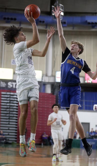 Bremerton’s Dallin Anderson (4) tries to get a hand on a shot by North Kitsap’s Harry Davies (12) at the Yakima SunDome on Saturday, March 2, 2024.