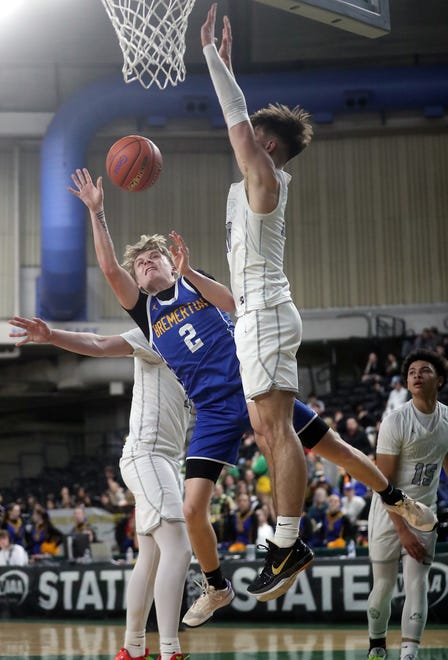Bremerton’s Trenton Bulmer (2) is fouled by North Kitsap’s Cade Orness as he goes up for a shot at the Yakima SunDome on Saturday, March 2, 2024.