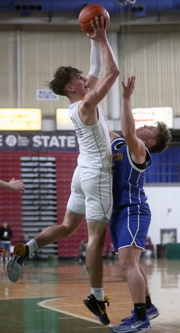 Bremerton’s Oliver Christian tries to block the shot of North Kitsap’s Cade Orness at the Yakima SunDome on Saturday, March 2, 2024.