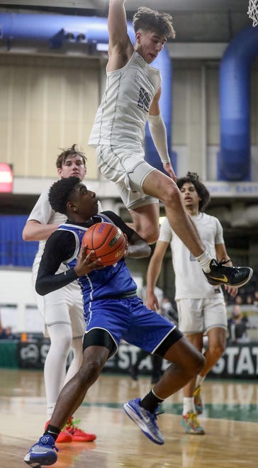 Bremerton’s Dyon Sellers sidesteps a block attempt by North Kitsap’s Cade Orness (10) during their Class 2A state championship game at the Yakima SunDome on Saturday, March 2, 2024. North Kitsap took home the third place trophy while Bremerton brought home fifth place.