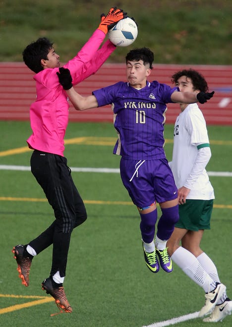 Skyline goalkeeper Thomas Malloy makes a grab for the ball before North Kitsap’s Pepe DeLuna can get a head on it during their season opener in Poulsbo on Saturday, March 9, 2024. North Kitsap won the game 2-1.