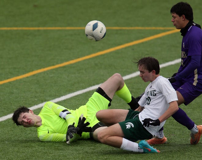 North Kitsap goalkeeper Justin Anderson blocks a shot by Skyline’s Auston Shepherd (20) during the season opener in Poulsbo on Saturday, March 9, 2024. North Kitsap won the game 2-1.