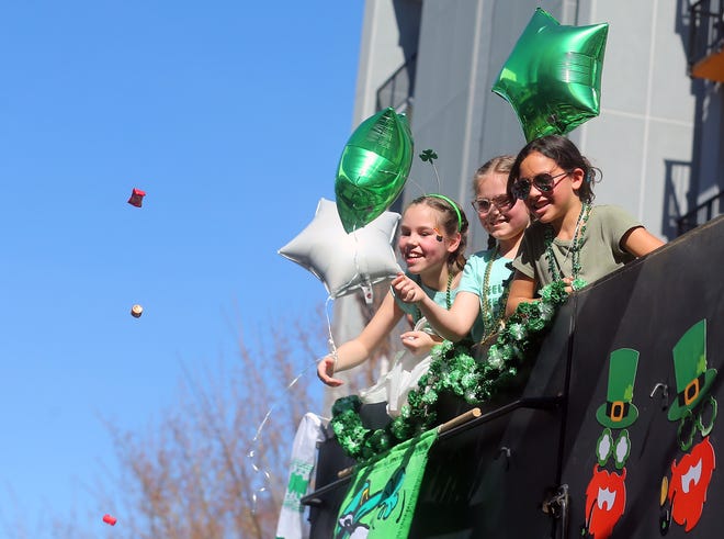 Candy is tossed by kids sitting high atop the Tim Ryan Construction float during Bremerton’s 30th. annual St. Patrick's Day Parade on Saturday, March 16, 2024.