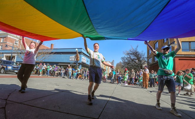 A giant pride flag is carried through the intersection of Pacific and 5th Street during Bremerton’s 30th. annual St. Patrick's Day Parade travels through downtown on Saturday, March 16, 2024.