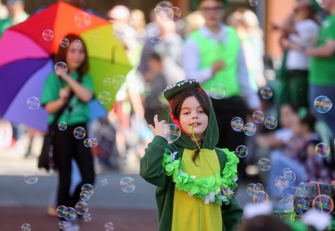 A youngster dressed like an alligator walks through the bubbles coming from the Charleston Business District float during Bremerton’s 30th. annual St. Patrick's Day Parade on Saturday, March 16, 2024.