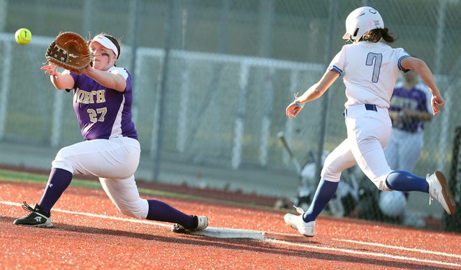 North Kitsap’s Kasey Wallace (27) lines up for a catch as Olympic’s Shaeinna Cherrey (7) bounds first on Tuesday, March 19, 2024. Cherrey was safe on the play.