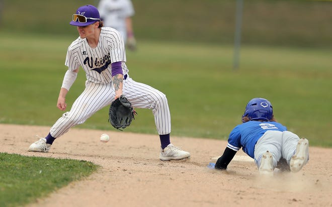 Olympic’s John Hutchins (2) slides into second ahead of the tag by North Kitsap’s Alex Elton (7) during their game in Poulsbo on Wednesday, March 20, 2024. Hutchins was safe on the play.
