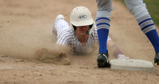 North Kitsap’s Alex Elton (7) steals third during their 5-1 win over Olympic in Poulsbo on Wednesday, March 20, 2024.