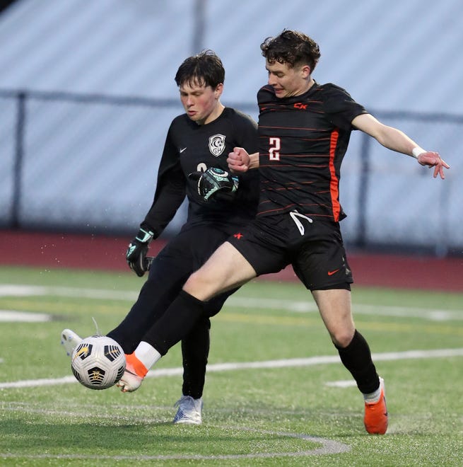 Central Kitsap’s Max Foster (2) gets a foot on the ball as Gig Harbor goalkeeper Trey Crosby tries to clear the ball during their game in Silverdale on Thursday, March 21, 2024.