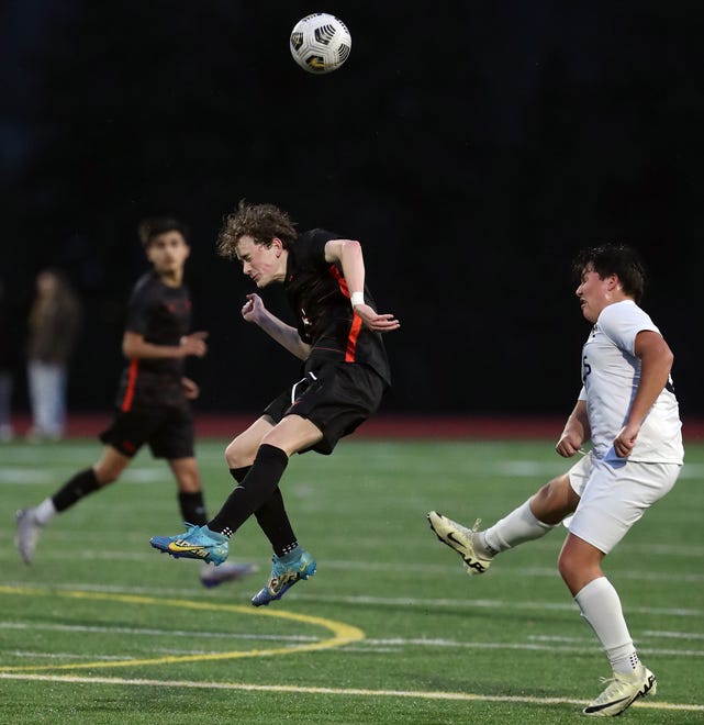 Central Kitsap’s Kamden Bailey leaps up for a header ahead of Gig Harbor’s Eli Hanson (21) during their 2-1 win over Gig Harbor in Silverdale on Thursday, March 21, 2024.