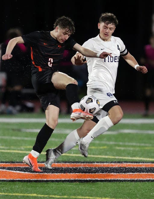Central Kitsap’s Max Foster (4) kicks the ball down the field while under the pressure of Gig Harbor’s Zach Spidahl (4) on Thursday, March 21, 2024.