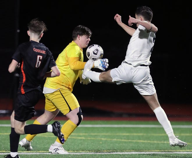 Central Kitsap goalkeeper Carson LeBeau makes a save as Gig Harbor’s Lucas Maharry (2) tires to get a foot on the ball in Silverdale on Thursday, March 21, 2024.