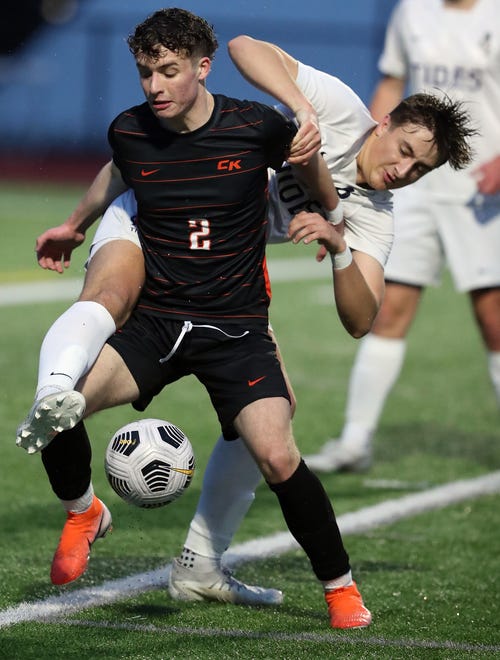 Central Kitsap’s Max Foster (2) fends off Gig Harbor’s Braden Smee’s attempt to gain control of the ball during their game in Silverdale on Thursday, March 21, 2024. CK won the game 2-1.