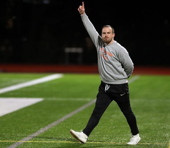 Central Kitsap head coach Patrick Leonard walks on the field with a number 1 in the air as the game ends with a 2-1 win over Gig Harbor in Silverdale on Thursday, March 21, 2024.
