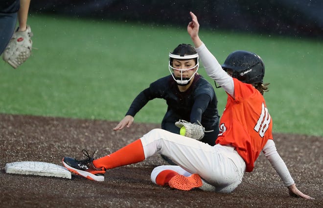 Central Kitsap’s Savvy Paulson (18) slides into third ahead of the tag by Kingston’s Cadence Robles in Silverdale on Friday, March 22, 2024.
